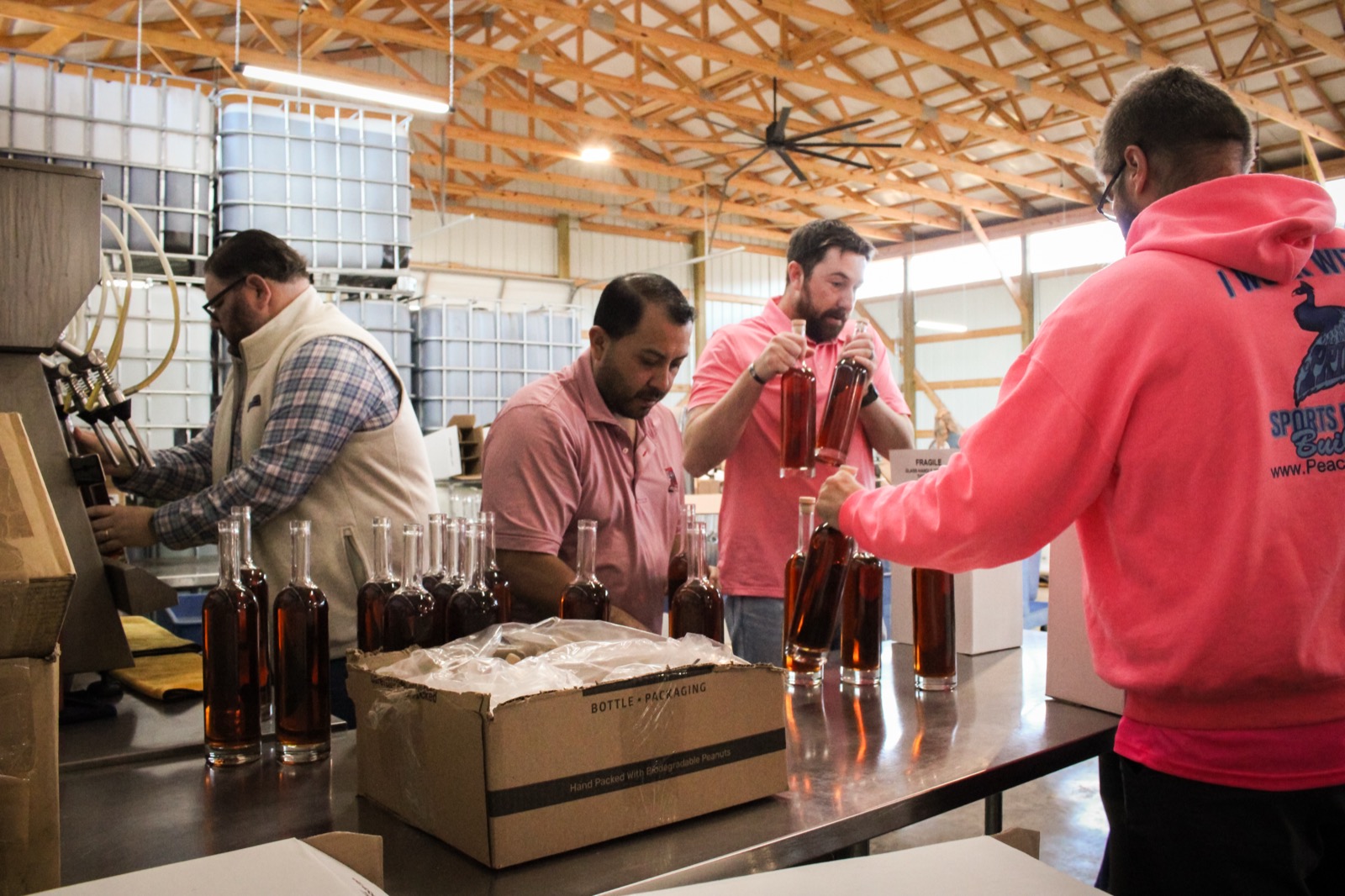 The team packaging Girl Dad Bourbon at the distillery
